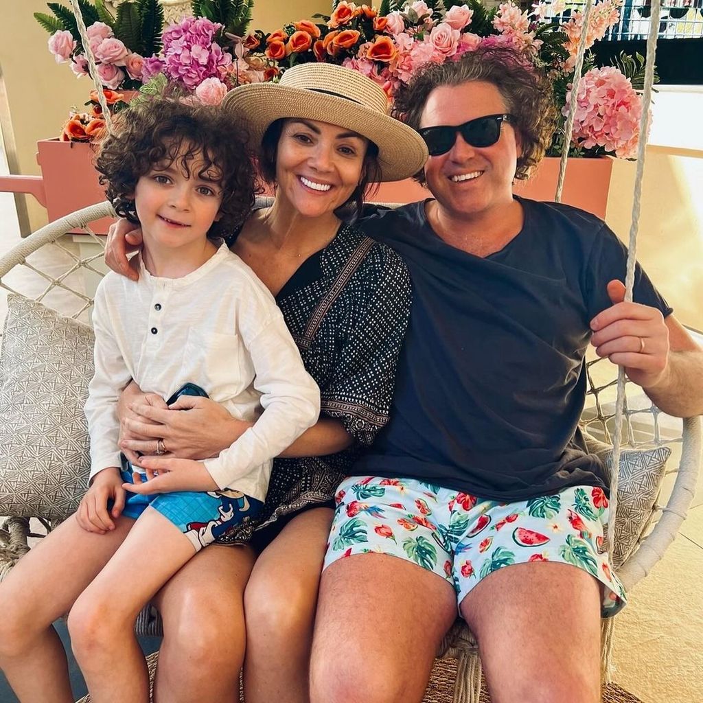 Martine McCutcheon and Jack McManus on an egg seat with their son