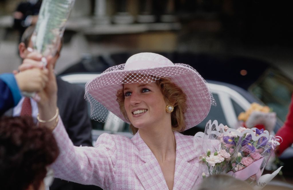 Diana in the tweed coat-dress and hat accepting flowers