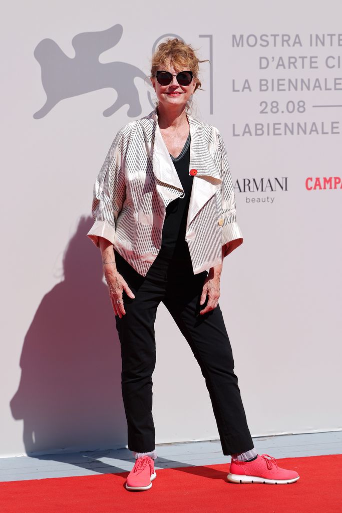 Susan Sarandon in a black pantsuit and silver jacket