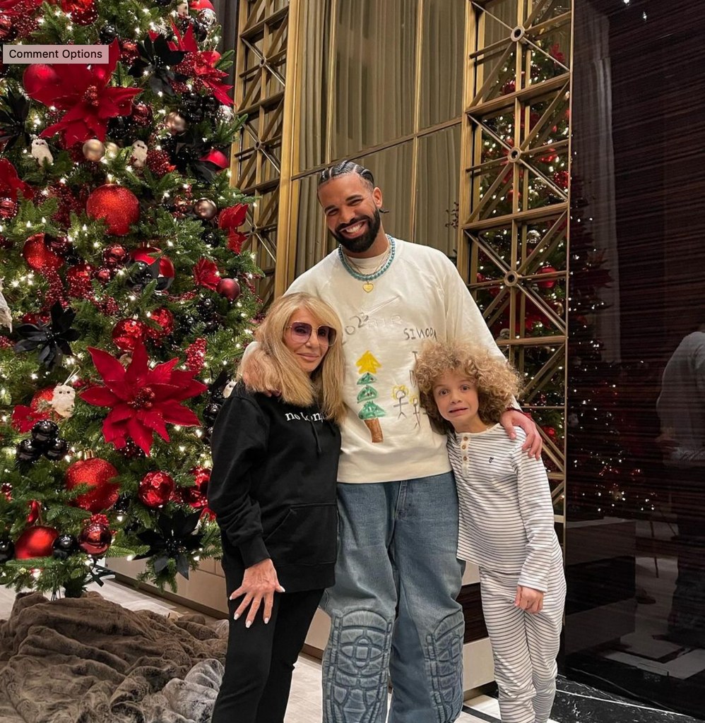 Photo shared by Drake on Instagram December 2023 posing inside his Toronto home with his mom Sandi Graham and his son Adonis, six