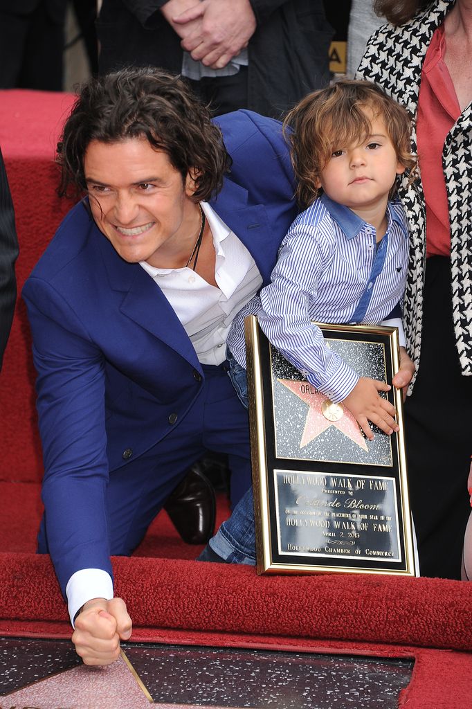 Orlando Bloom and son Flynn pose at the ceremony that honored him with a Star on the Hollywood Walk of Fame, 2014