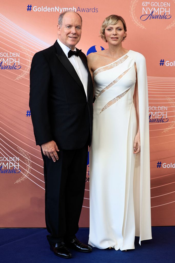 Princess Charlene in white jumpsuit with Albert