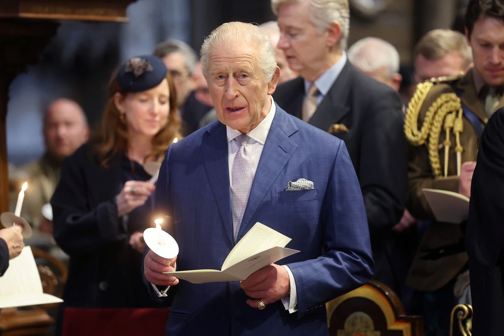 King Charles holding a candle at Advent service