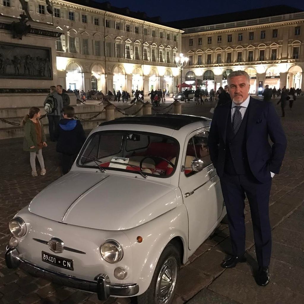Paul hollywood standing next to white car 