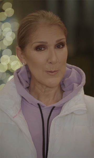 Celine Dion in a purple and white jacket
