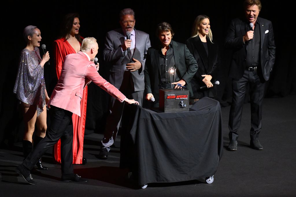 Simon Pegg presents Tom Cruise with a birthday cake during the Australian Premiere of "Mission: Impossible - Dead Reckoning Part One" presented by Paramount Pictures and Skydance at ICC Sydney on July 03, 2023, in Sydney, Australia