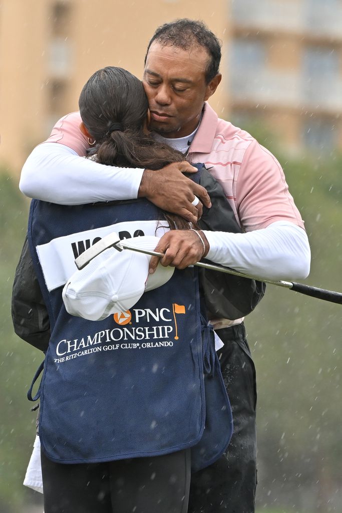 ORLANDO, FLORIDA - DECEMBER 16: Tiger Woods hugs his daughter and caddie, Sam Woods, on the 18th green during the first round of the PNC Championship at Ritz-Carlton Golf Club on December 16, 2023 in Orlando, Florida. (Photo by Ben Jared/PGA TOUR via Getty Images)