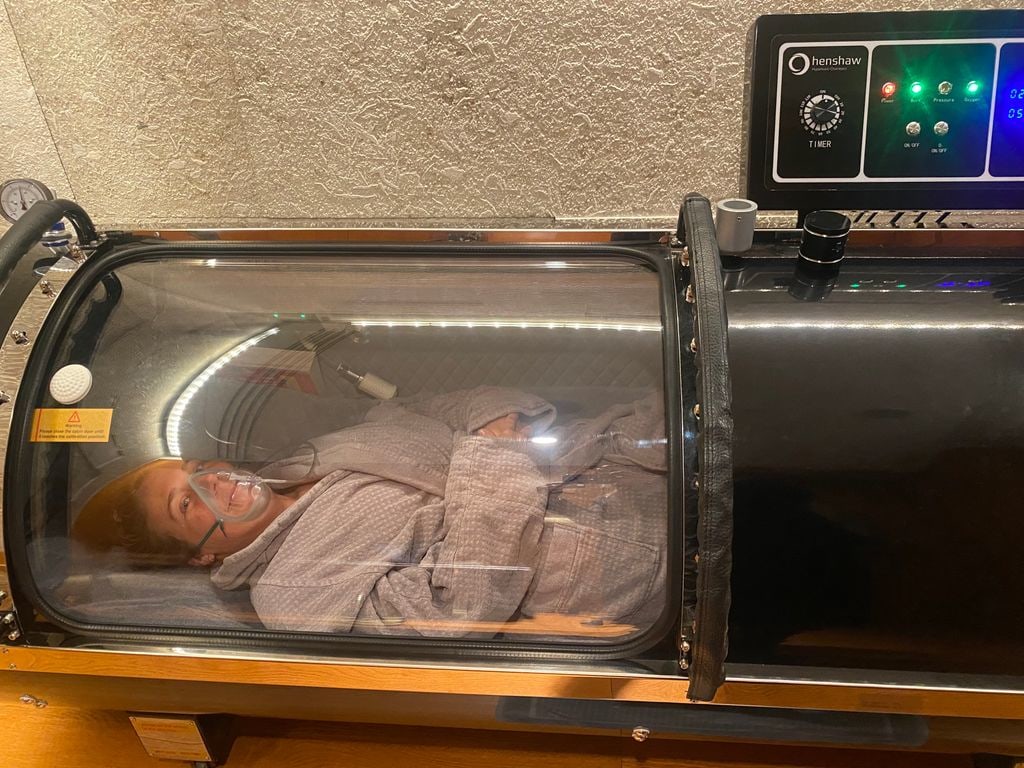 woman in a dressing gown in an oxygen chamber 