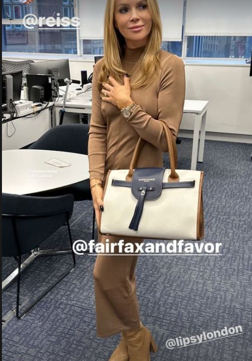 Amanda Holden in a skintight brown dress with a handbag