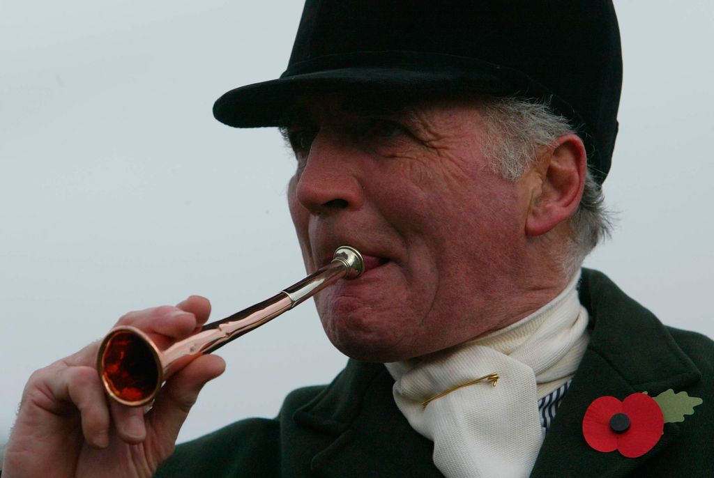 Ian Farquhar blowing on a horn