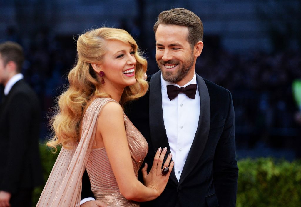 Blake Lively places a tender hand on Ryan Reynolds as they are on red carpet