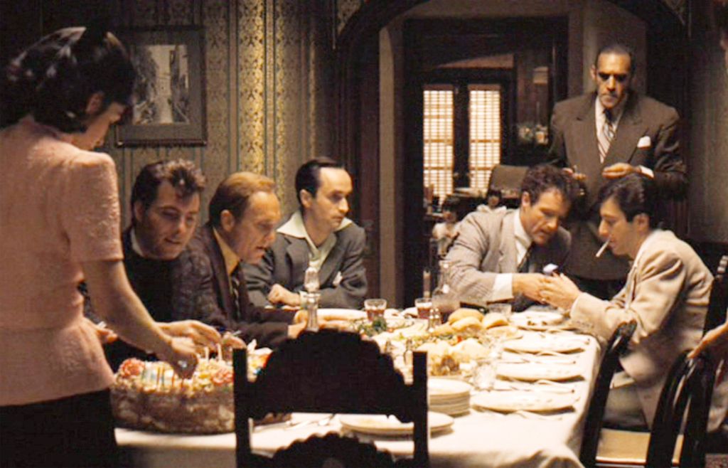 from left, Talia Shire (back to camera) as Connie Corleone, Gianni Russo as Carlo Rizzi, Robert Duvall as Tom Hagen, John Cazale as Fredo Corleone, James Caan (seated at head of table) as Sonny Corleone, Abe Vigoda (standing) as Sal Tessio and Al Pacino as Michael Corleone
