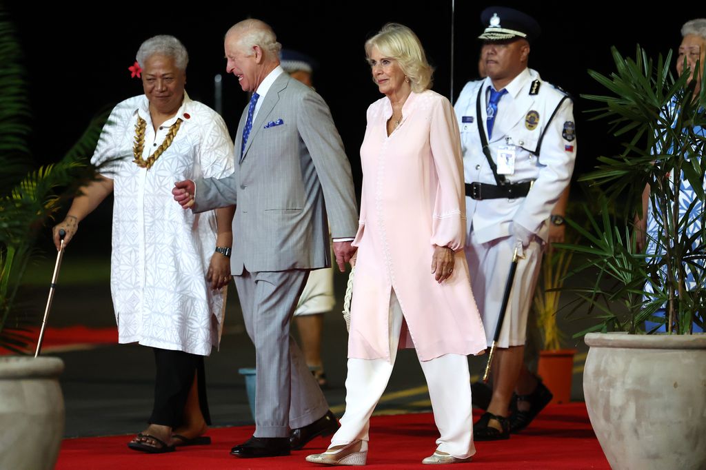 King Charles III and Queen Camilla walk with Prime Minister of Samoa Fiame Naomi Mata'afa