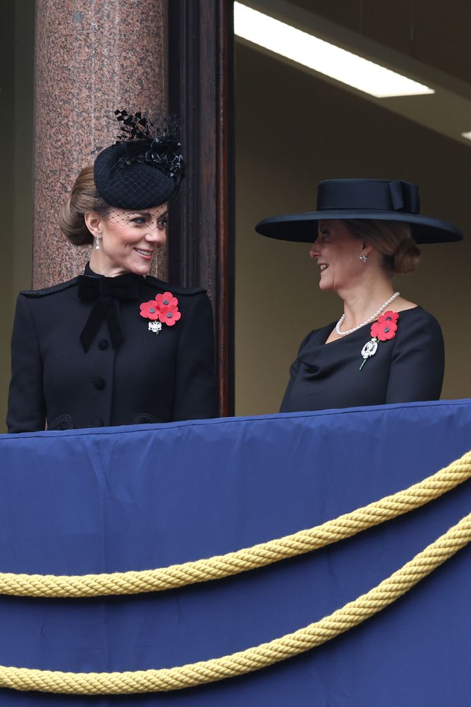 The Princess of Wales and the Duchess of Edinburgh smile as they stand on the balcony during the National Service of Remembrance