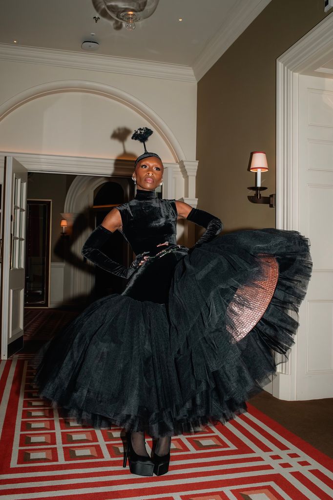 Cynthia Erivo wears a black tulle gown, black heels and a black fascinator for the Wicked premiere