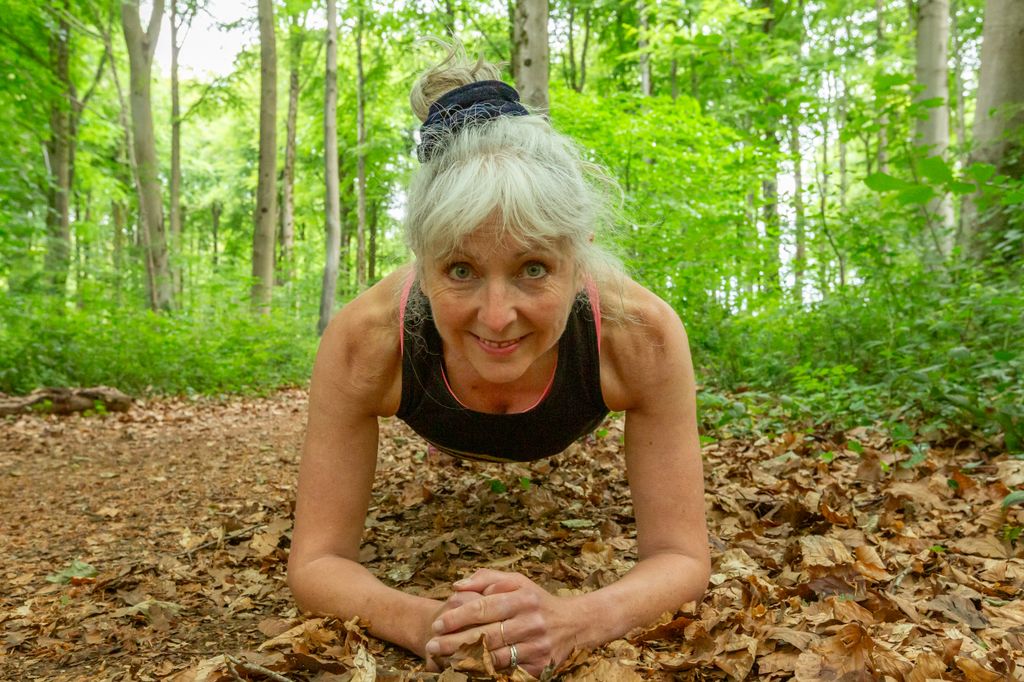 Woman doing a plank in the forest