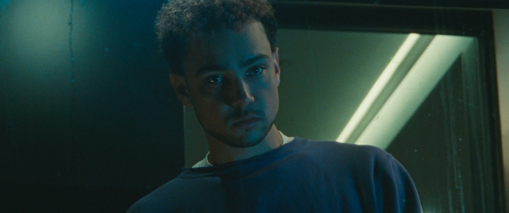 close-up of man in dimly lit room