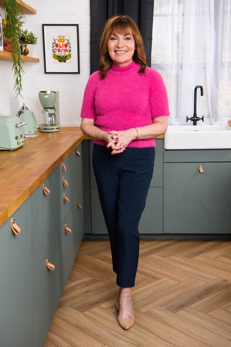 Lorraine Kelly in slim trousers and pink top