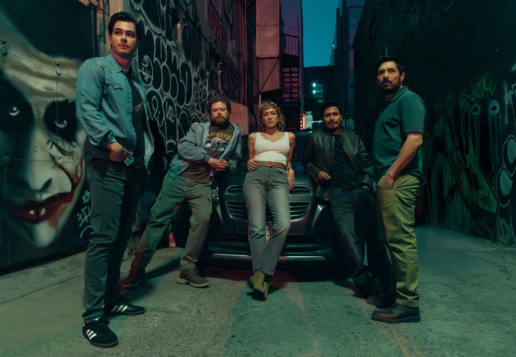 group of people standing by car in alley way