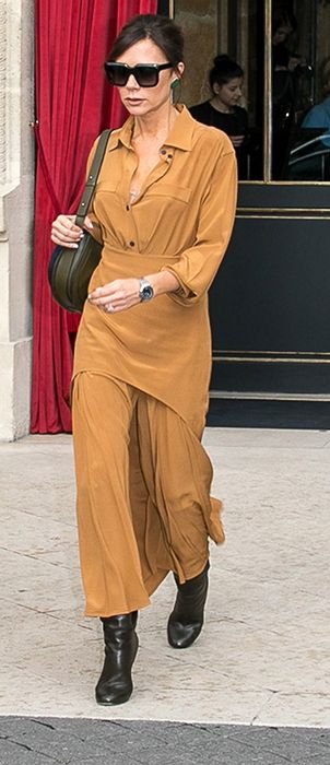 Victoria Beckham wears tan shirt and skirt from her own collection in ...