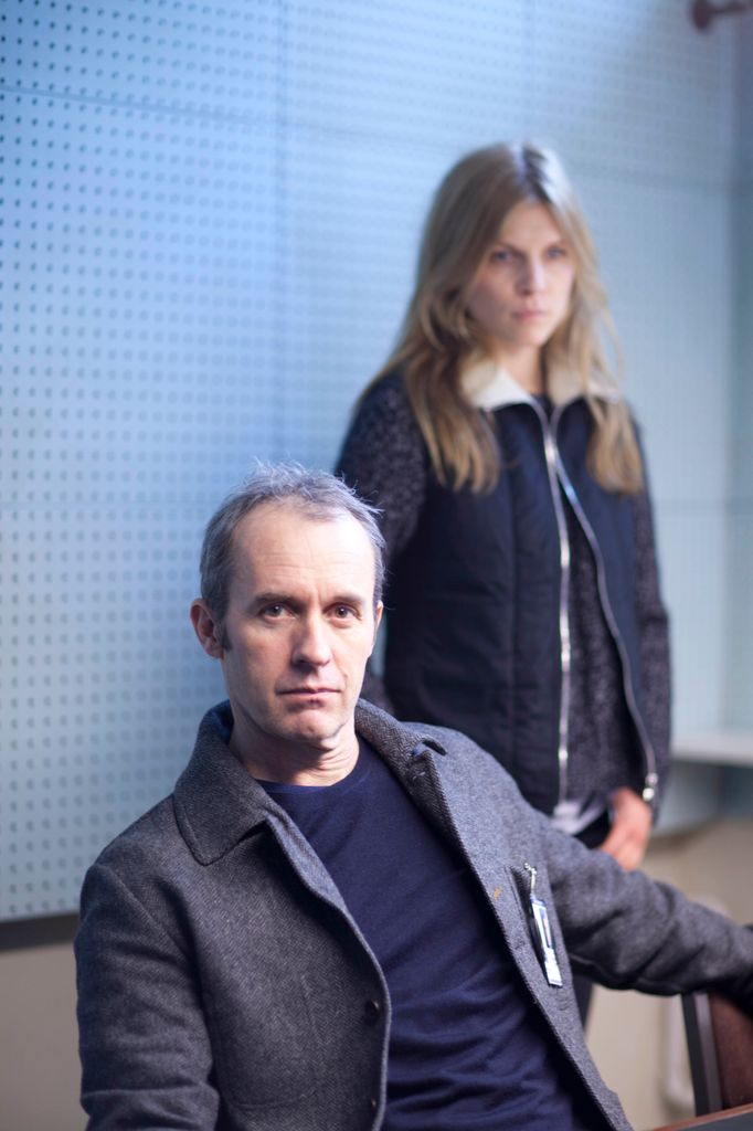 man sitting next to standing woman