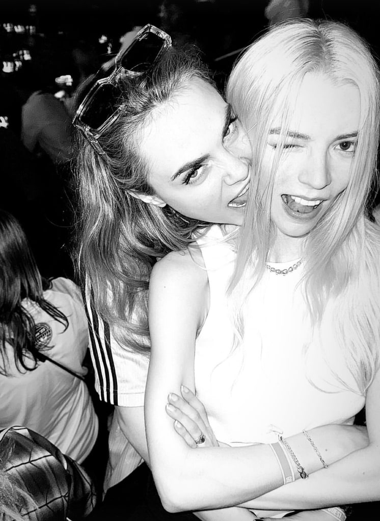 Anya taylor joy and Cara Delevingne hugging at  Oasis gig