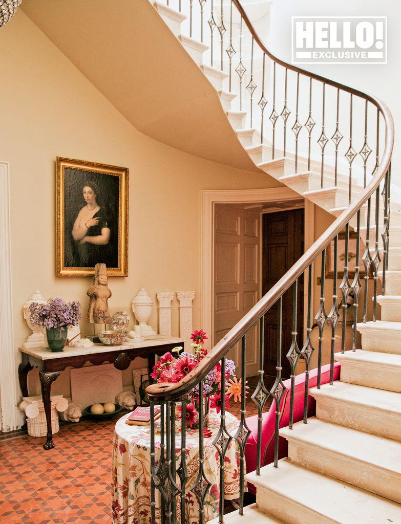 Conran home entrance hall with winding staircase antiques and terracotta tiles