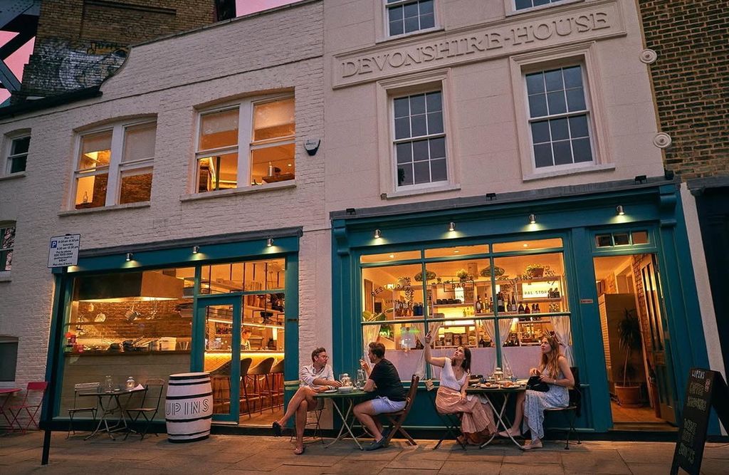 outside of restaurant at night with tables out front
