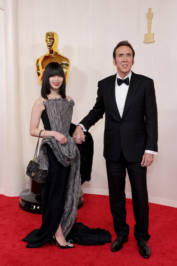Riko Shibata and Nicolas Cage attend the 96th Annual Academy Awards 