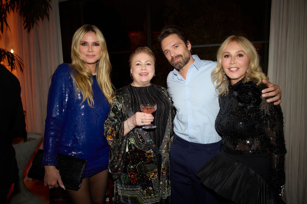 Heidi Klum (L) posrs with Sebadtain Stan and Anastasia Soare