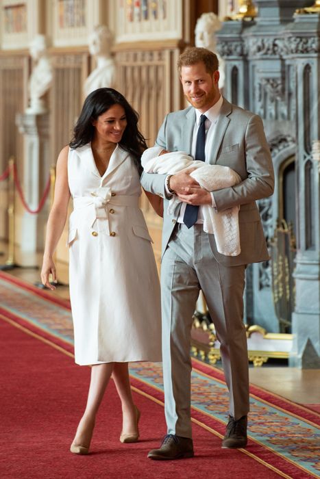 prince harry and meghan walking inside windsor castle with baby archie