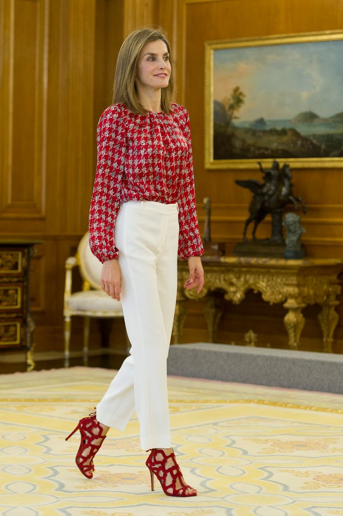 Queen Letizia of Spain in white trousers with red top and heels