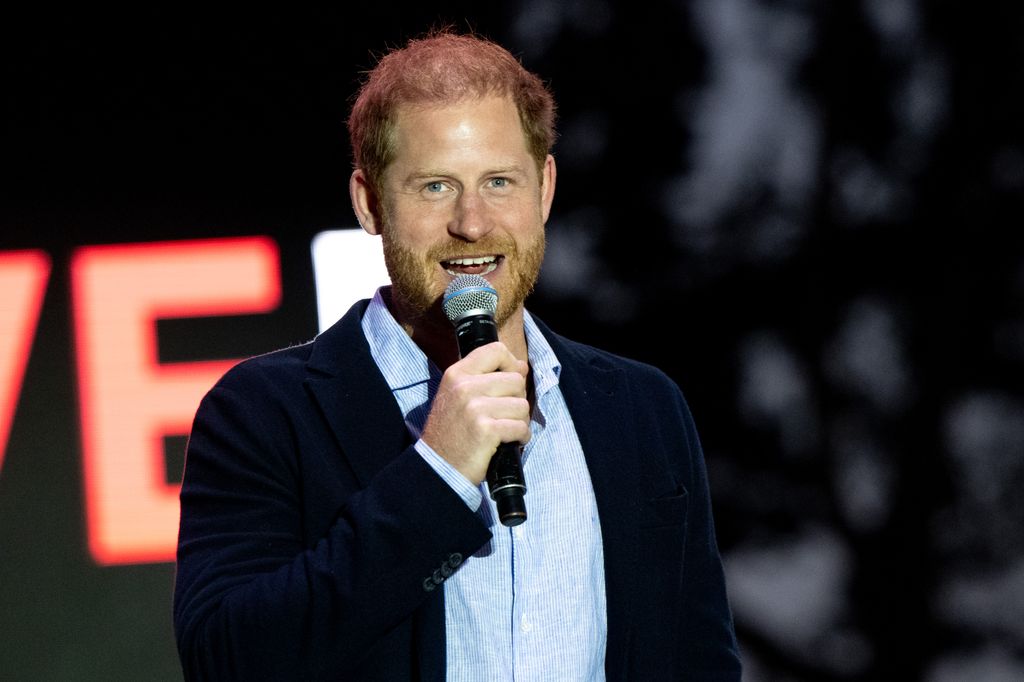 Prince Harry holding a microphone