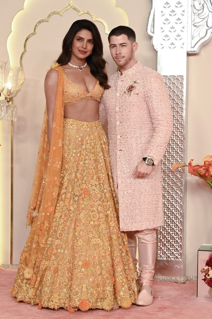 Priyanka Chopra Jonas and her husband Nick Jonas pose for photos as they arrive to attend the wedding ceremony of Anant Ambani and Radhika Merchant