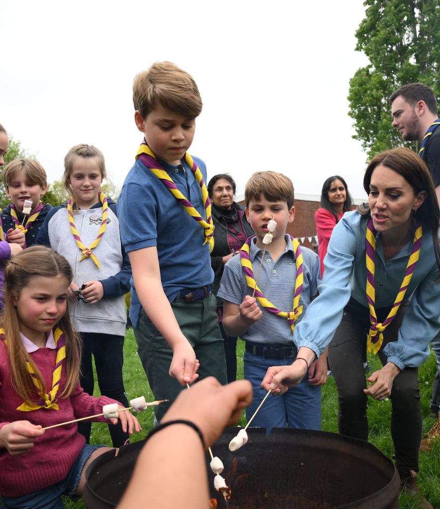 Britain's Princess Charlotte of Wales, Britain's Prince George of Wales, Britain's Prince Louis of Wales and Britain's Catherine, Princess of Wales toast marshmallows as they take part in the Big Help Out