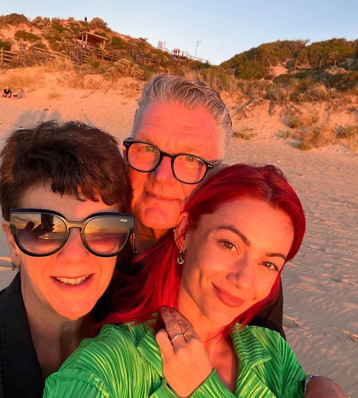 Dianne Buswell with an elderly couple on the beach