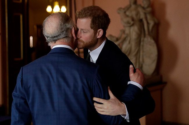 Prince Harry kissing his father Charles in the cheek