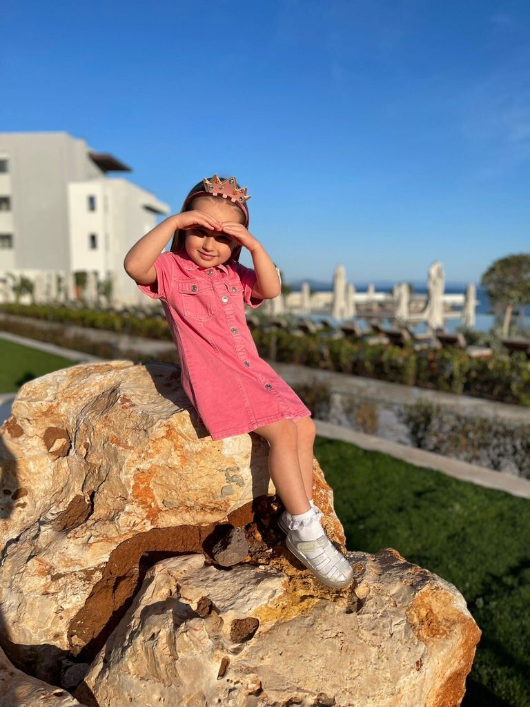 Ella Jordan daughter of James Jordan posing on a rock 