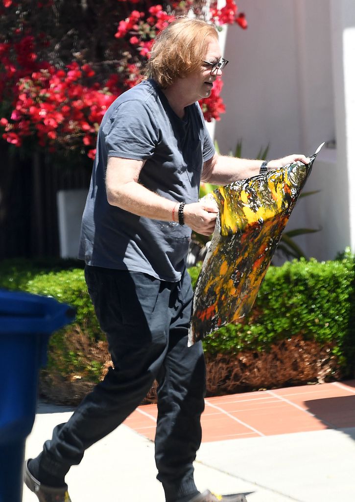 david caruso carrying art work