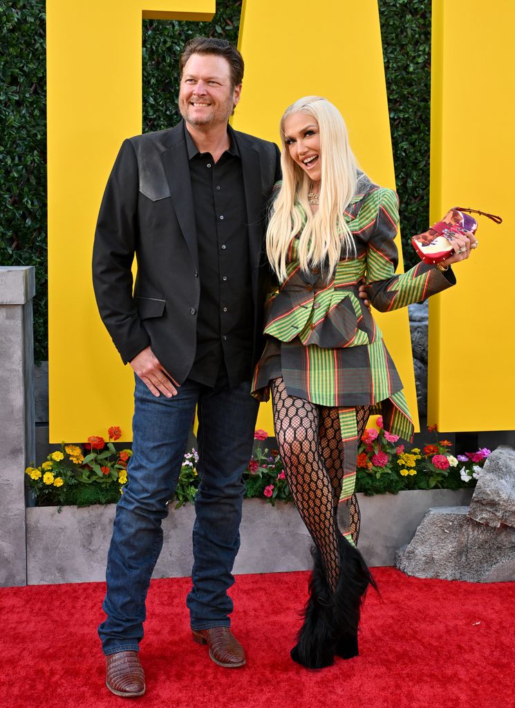 Gwen Stefani in plaid and fishnets with blake on red carpet