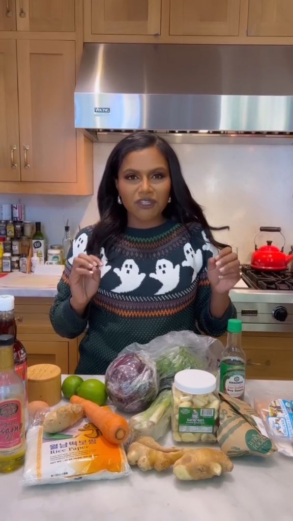 Mindy Kaling with ingredients on the kitchen side