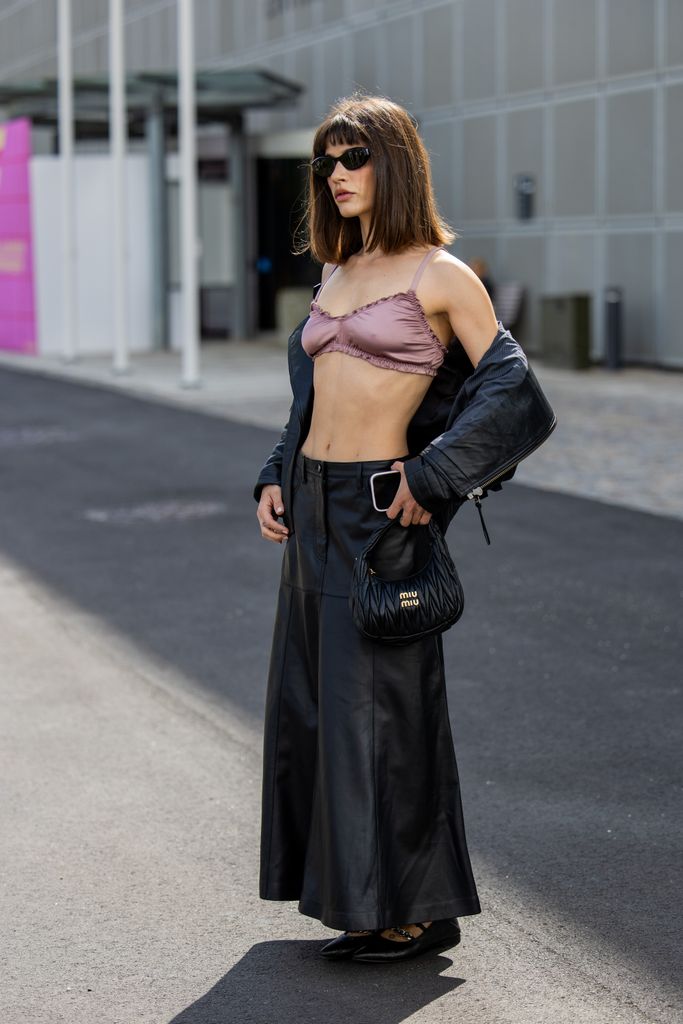 Lea Naumann wears black leather jacket, skirt, Miu Miu bag, cropped top outside Munthe during day four of the Copenhagen Fashion Week (CPHFW) SS25 on August 08, 2024 in Copenhagen, Denmark. (Photo by Christian Vierig/Getty Images)