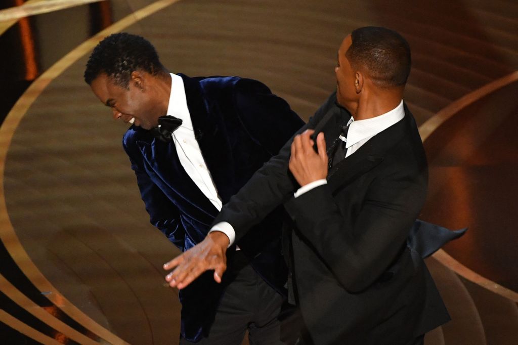 Will Smith (R) slaps US actor Chris Rock onstage during the 94th Oscars at the Dolby Theatre in Hollywood, Californi