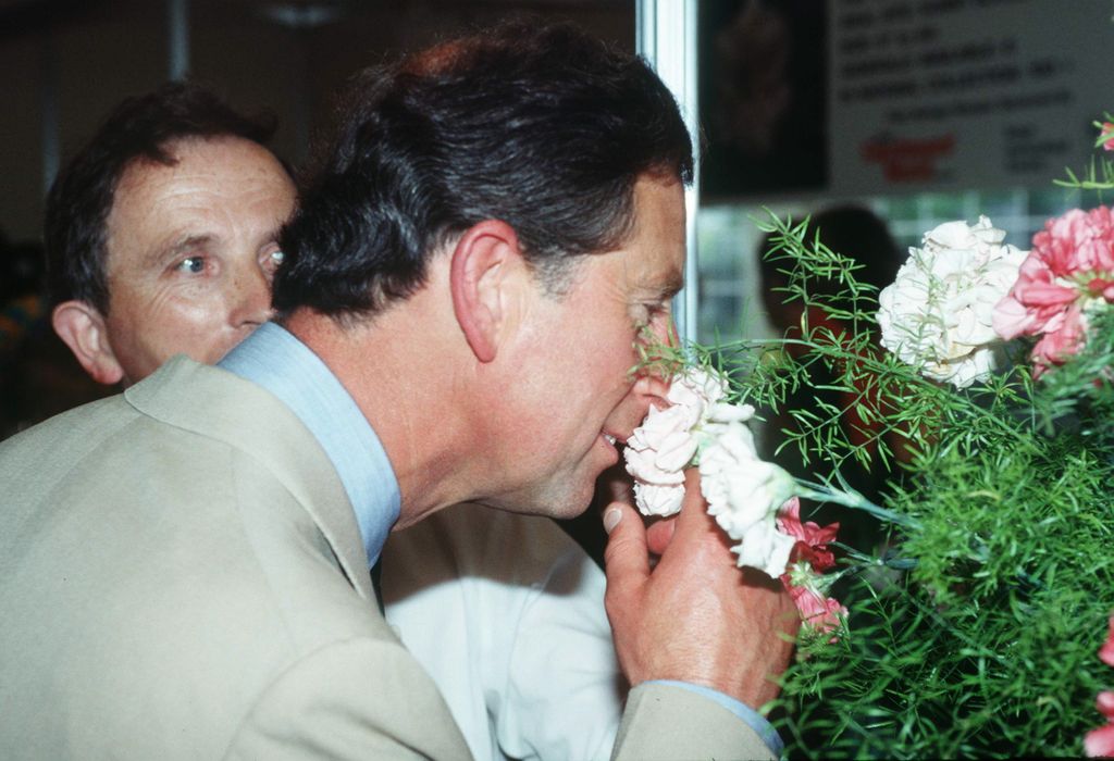 A young King Charles smelling some flowers at the Hampton Court Palace Flower Show in Surrey