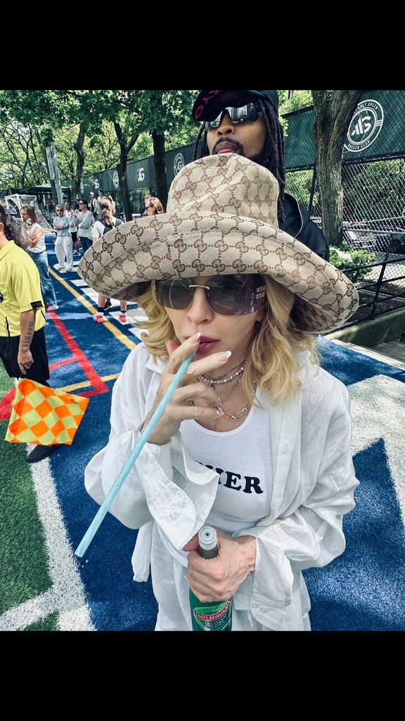 Madonna in Gucci hat and white outfit