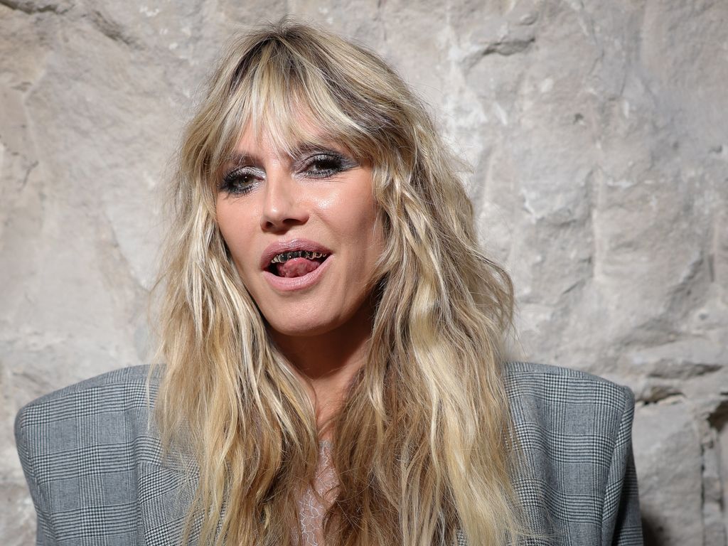 photo of heidi klum wearing gold grillz