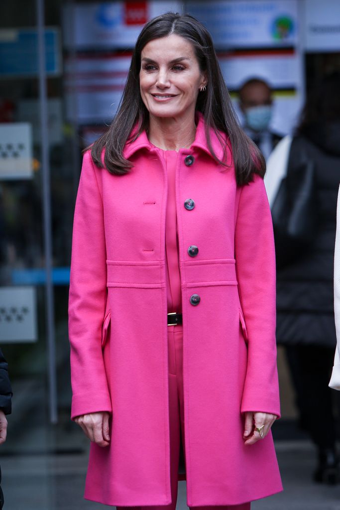queen letizia of spain wearing bright pink coat and trousers