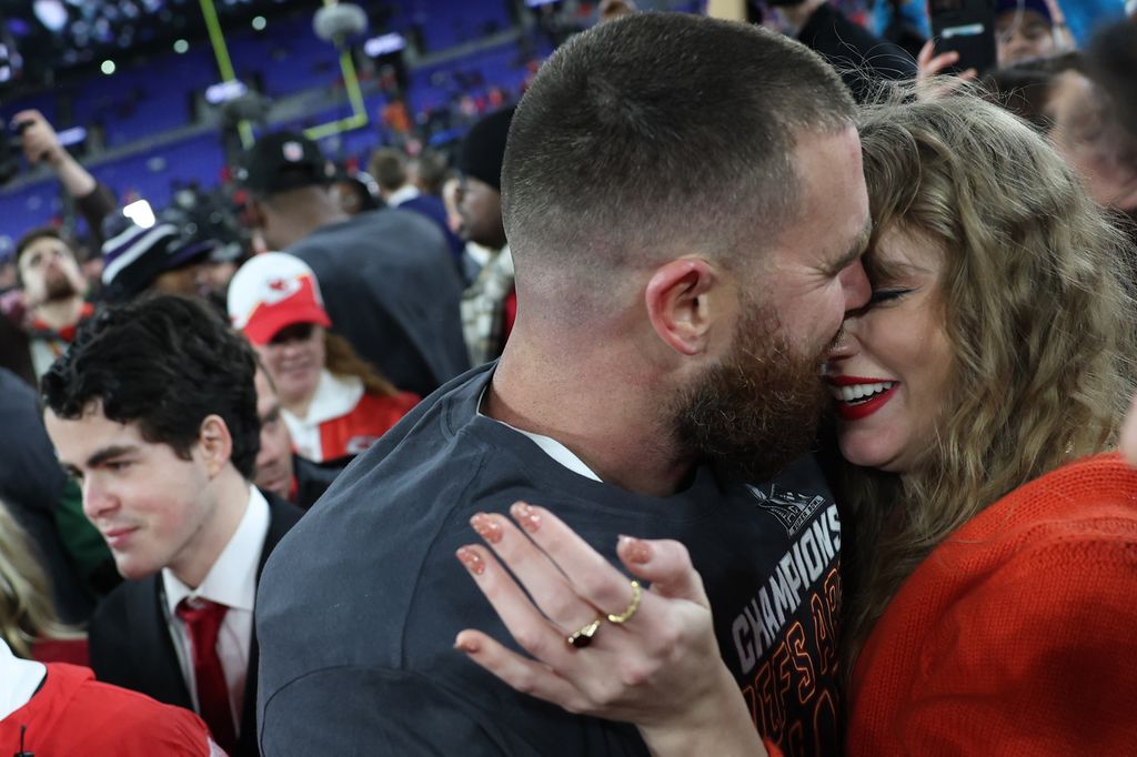 Travis Kelce #87 of the Kansas City Chiefs embraces Taylor Swift after a 17-10 victory against the Baltimore Ravens in the AFC Championship Game at M&T Bank Stadium