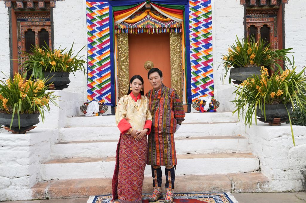 Ugen Choden Namgyel and Prince Jigyel standing outside a building
