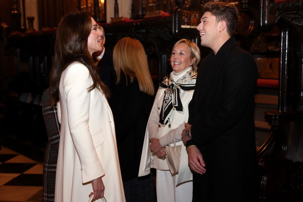Princess Kate speaks with Roman Kemp at The "Together At Christmas" Carol Service at Westminster Abbey in December 2023